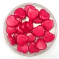 Detailed close-up of pink heart-shaped acrylic beads, perfect for DIY jewelry making crafts. - Solid Rose Red