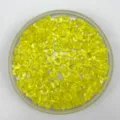 Yellow acrylic ice cubes detail closeup, small drilled crystal beads for party decoration - Yellow