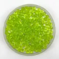 Close-up detail of lime green acrylic wheel beads in a clear tray for DIY crafts and curtains. - Grass Green