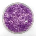 Detail view of purple transparent heart plastic beads in a round container, perfect for DIY jewelry. - Transparent Purple