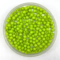 Close-up of vibrant lime green faceted acrylic round beads, perfect for DIY jewelry and crafts. - 6mm / Grass Green