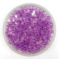 Close-up of 6mm purple acrylic faceted wheel beads for DIY handmade jewelry crafts. - Purple
