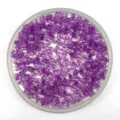 Close-up of purple transparent star acrylic beads in round tray for DIY jewelry making - 6mm / Purple