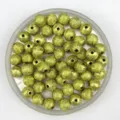 Detail shot of gold frosted acrylic round beads with wrinkled texture, perfect for DIY jewelry making. - Gold
