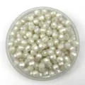 White faceted acrylic beads detail showing sparkling multi-cut loose beads in a clear box. - 12mm / Pearly White