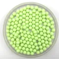 Close-up view of light green solid plastic round acrylic beads detail and smooth texture. - 6mm / Light Green
