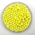 Detail view of solid yellow acrylic round beads, perfect for DIY crafts and toy marble displays. - 6mm / Lemon Yellow