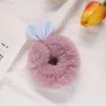 Close up detail of cute plush rabbit ear hair scrunchie, soft fluffy material for autumn winter. - Light Purple and Blue
