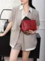 Genuine leather crossbody bag detail shot, stylish red shoulder bag for women daily wear. - Burgundy