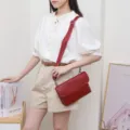 Red leather crossbody bag detail view, showing fine texture, adjustable strap and metal hardware. - Large Size (24x4x16.5cm) / Red