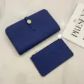 Detailed view of blue leather passport holder and card case set with metal clasp design. - Sapphire Blue