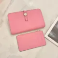 Detail shot of pink genuine leather passport holder and card case set with metal clasp closure. - Watermelon red