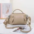Detailed view of the genuine leather crossbody shoulder bag featuring a wide strap and hardware. - 23*11*15cm / Rice Camel