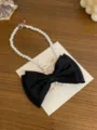 Close-up detail of white pearl necklace featuring a large black fabric bow pendant. - Bowknot Pearl Necklace(GC1526) / Black