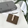 Close-up detail of brown color-block leather women wallet with snap closure and zipper. - Khaki