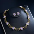Detailed close-up of luxury gold-plated purple crystal gemstone necklace and earrings set. - Purple