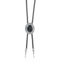 Detailed close-up of vintage oval bolo tie with black stone, braided leather cord and metal tips. - Black