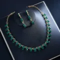 Detailed close-up of green rhinestone necklace and earrings set featuring sparkling crystals. - Green Zirconia Set
