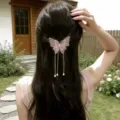 Close-up detail of the elegant pink mesh butterfly hair clip with hanging pearl tassels. - Butterfly Tassel Hair Clip / Pink (C02-21)