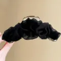 Detailed view of a black mesh ruffled hair claw clip, showing exquisite fabric texture. - Black Mesh Claw Clip