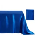 Satin tablecloth detail showing smooth glossy fabric texture and neat folded fabric sample. - Blue