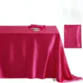 Close-up detail of smooth fuchsia satin tablecloth showing elegant drape and glossy texture. - Rose Red