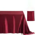 Detail view of the elegant burgundy satin rectangular tablecloth, glossy fabric for decor. - Burgundy