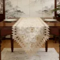 Detailed view of vintage hollow lace table runner with delicate floral embroidery for chic decor. - Gold Plum Blossom / 40X150cm