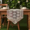 Detailed view of elegant white lace table runner with floral embroidery on wooden dining table. - 40*150 cm / Khaki