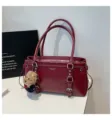 Burgundy leather tote bag with shoulder straps, front buckles, and cute bear pendant. - With Pendant / Red