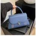 Elegant blue mini handbag with structured flap design and chic metal clasp closure. - Blue