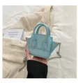 Light blue mini handbag with snake pattern texture, double handles and metal chain strap. - Blue