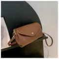 Brown PU leather crossbody shoulder bag with flap closure and stylish minimalist design. - Brown