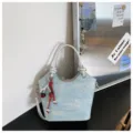 Stylish light blue denim bucket bag variant featuring a silver handle and cute cherry charm. - Cherry Pendant / Silver