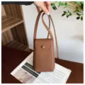 Brown textured leather cross-body phone bag, mini vertical shoulder bag variant. - Brown