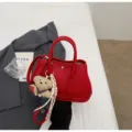 Red leather fashion handbag with cute bear charm, elegant crossbody tote bag for women. - With Pendant / Red