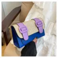 Details of the blue and straw patchwork Cambridge bag with purple buckle straps. - Blue
