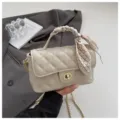 Beige quilted shoulder bag with chic chain strap, elegant turn-lock and stylish scarf. - White