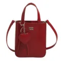 Red patent leather small crossbody square bag featuring heart charm, stylish daily tote. - Red