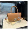 Stylish brown leather top handle shoulder bag with metal lock and mini bag charm for women - Brown