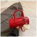 Red cylindrical handbag for women, trendy patent leather pillow shoulder bag with fluffy charm. - With Pendant / Red