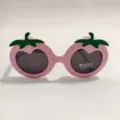 Cute strawberry shaped children sunglasses detail, pink frame with white dots and green stem. - Pink