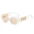 Gafas de sol ovaladas de moda con montura rosa translúcida y detalles dorados vintage. - Montura Champán Lente Champán