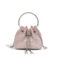 Nahaufnahme des luxuriösen rosa Strass-Beuteltaschendetails mit Metallrundgriff und Kette. - Rosa