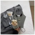 Chic light blue bucket bag with top handle, elegant shoulder strap and cute plush dog charm. - With Pendant / Blue