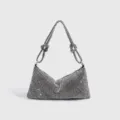 Impresionante bolso de hombro de pedrería plateada con elegantes correas anudadas de fiesta. - Plateado