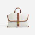 Canvas messenger bag for women, stylish color-block shoulder bag with top handle and buckle. - White