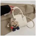 White litchi pattern shell crossbody bag featuring cute bear pendant, stylish and versatile. - With Pendant / White