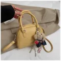 Korean style yellow dome handbag litchi grain PU leather crossbody shell bag variant - With Pendant / Yellow