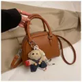 Brown lychee pattern dome handbag with cute bear pendant, stylish crossbody shell bag. - With Pendant / Brown